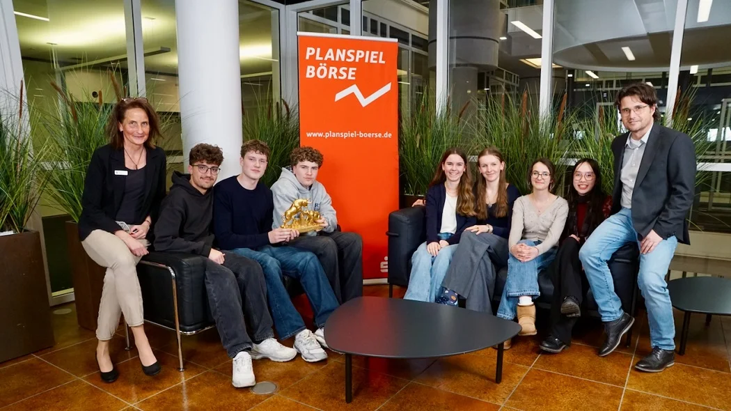 Team „Die Affenbande“ (links) und Team „Marienkäfer“ und Team „BuyByeBörse“ (rechts) vom Franz-Marc-Gymnasium Markt Schwaben, mit Erika Hehlen von der Kreissparkasse (ganz links) und betreuendem Lehrer Herrn Schweiger (ganz rechts)